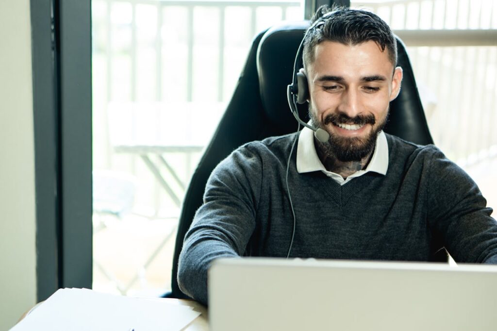 Bearded Man Wearing Headphones while Working in the Office